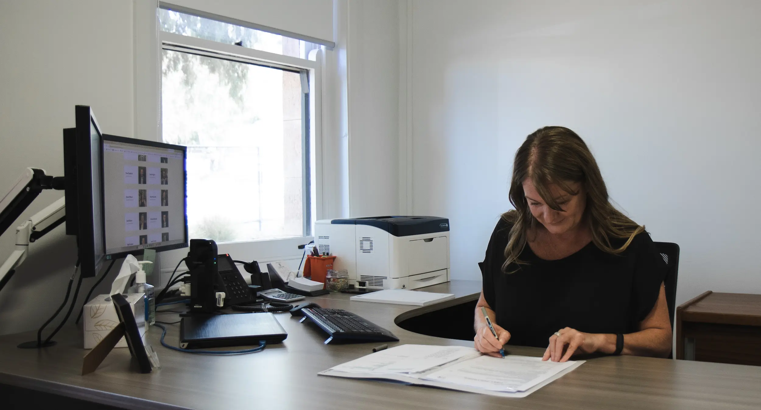 Liedig and Associate employee sitting at desk focusing on work.